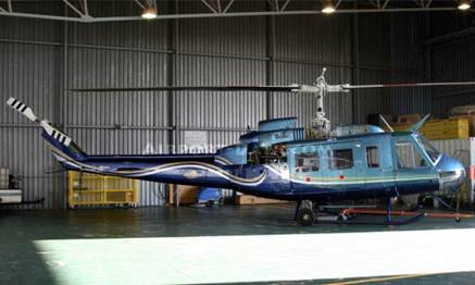 A Blue and Navy Blue Color Helicopter Inside a Shed