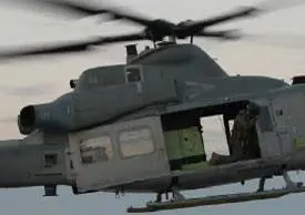 A Grey Color Helicopter Flying in the Air