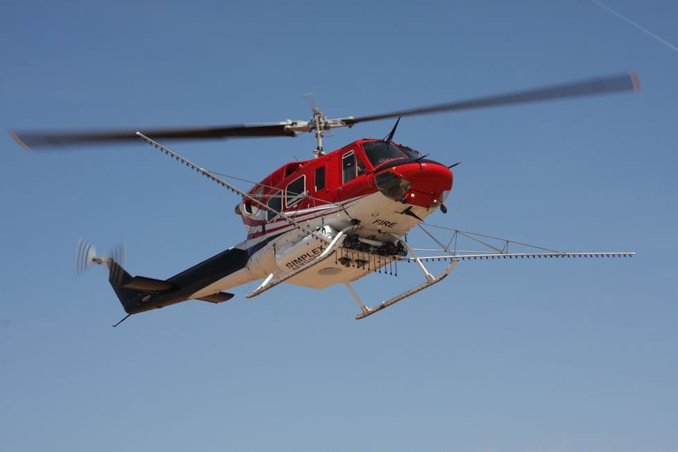 A helicopter with two different blades flying in the air.